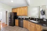 Black stainless steel appliances that stay and deep sink in counter that overlooks the Great Room.