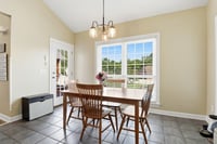 Another view of the Breakfast area with a view of the back yard and pool.