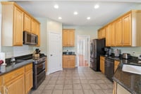 Tile Floors and Granite Counter Tops with plenty of cabinet space in Kitchen.